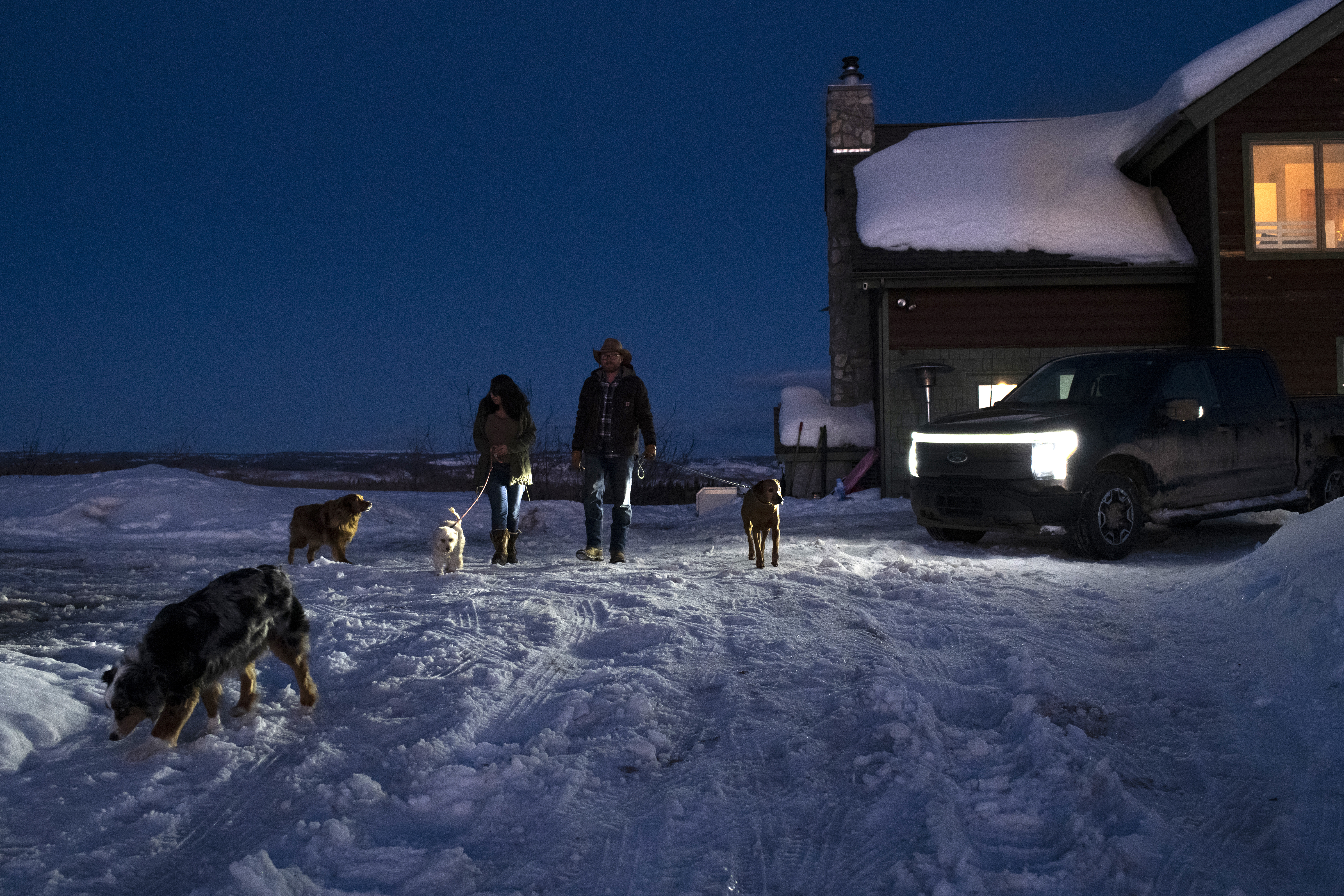 Amy Westby and Ben Westby walk the dogs they’re boarding with use of the zone lighting from their Ford F-150 Lightning on Sunday, March 17, 2024 at their home in New Castle, Colorado. Rachel Woolf for Ford